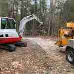 Tree tops being brought to wood chipper
