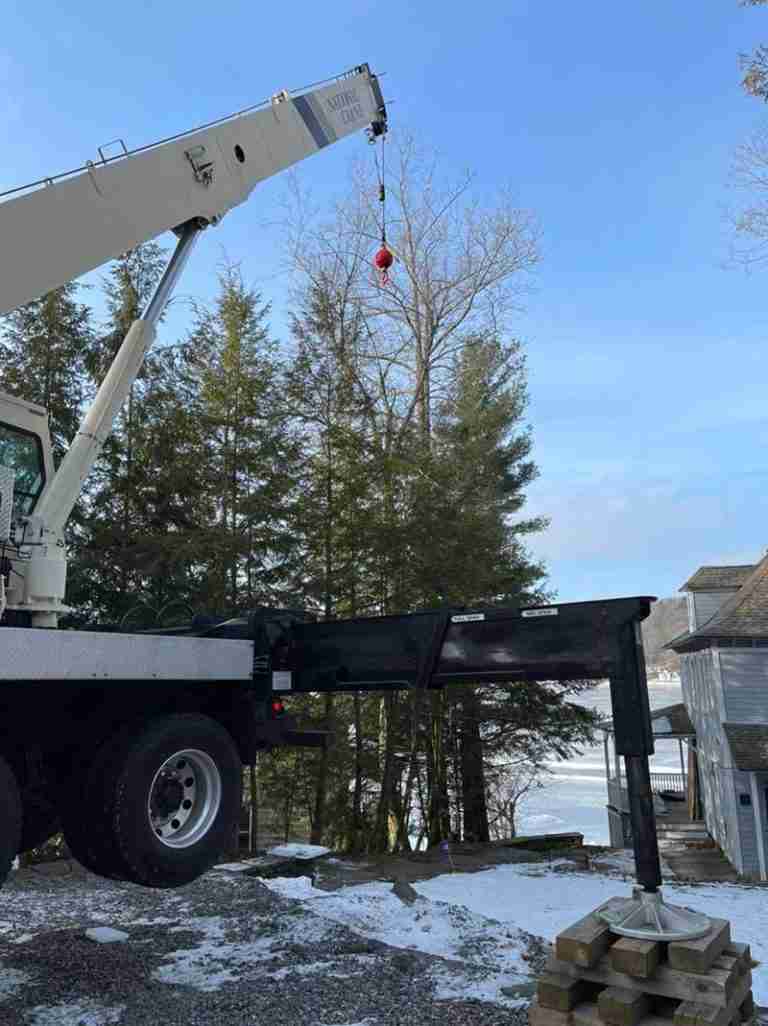 Setting up crane for tree removal at Highland Lake property in Winchester, CT.