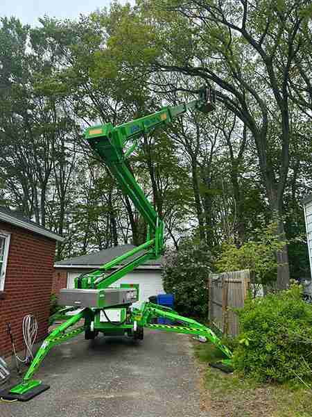 Ninety-foot tracked lift being used for storm damage tree removal in Harwinton.