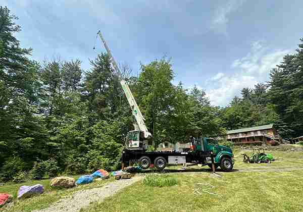 Crane is set up for dead Ash Tree removals in Winsted at Greenwood Trails.