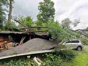 July 4th storm damage in Torrington showing trees having destroyed a building and separated the roof.